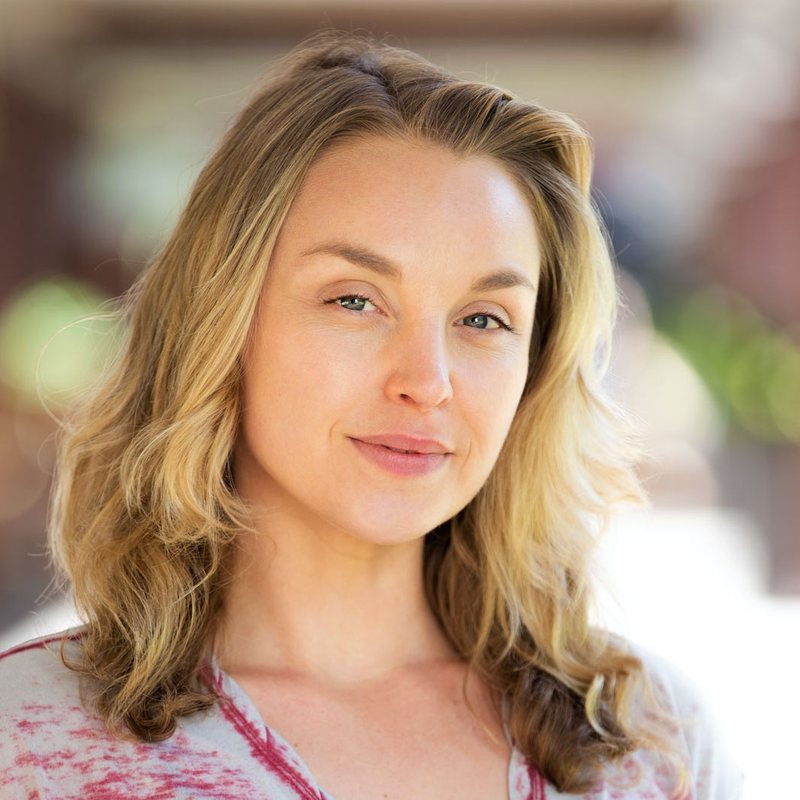 Emily Bedard, vinyasa yoga teacher at The Castro Room in San Francisco, close-up portrait with long wavy blonde hair in soft natural light